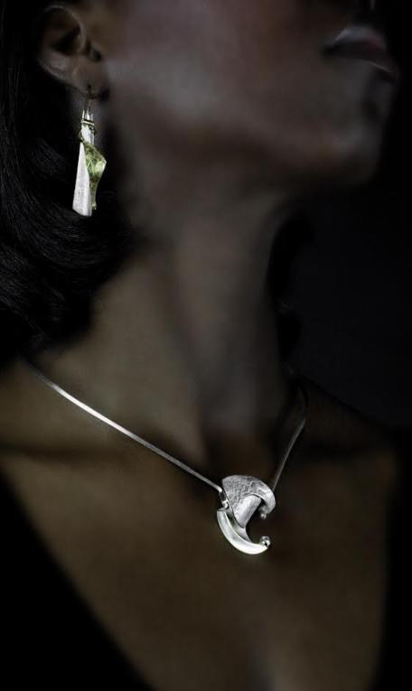 A Woman Wearing a Stone and Metallic Bar Shaped Earrings