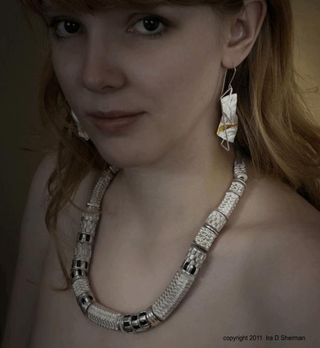 A Woman in a Metallic Cube Detail Necklace With Earrings