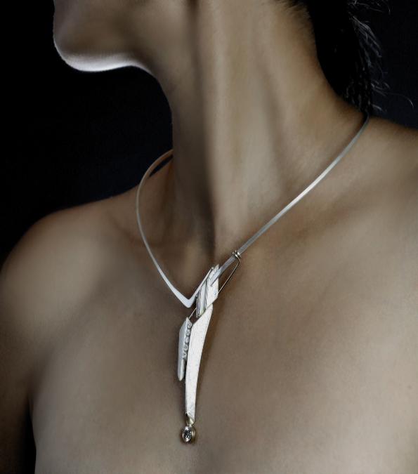 A Woman Wearing a Metallic Chain With a Bar Pendant