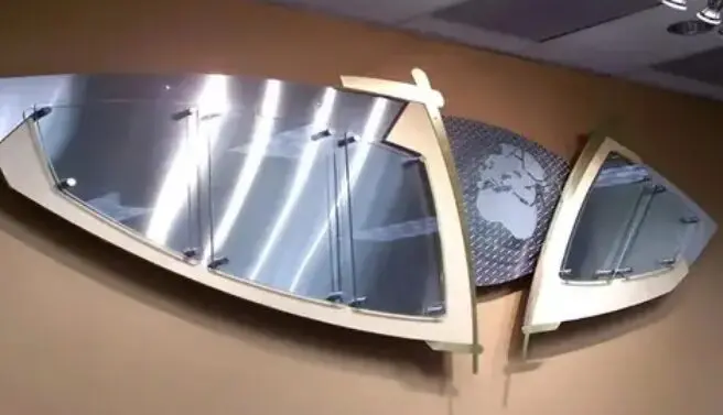 An architectural mirror embellished with two surfboards mounted on the wall.