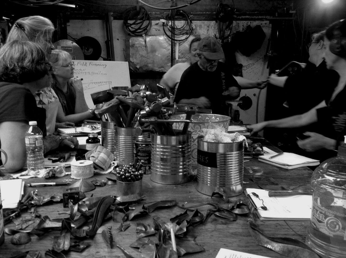 A group of people collaborating at a table during one of Ira Sherman's workshops.
