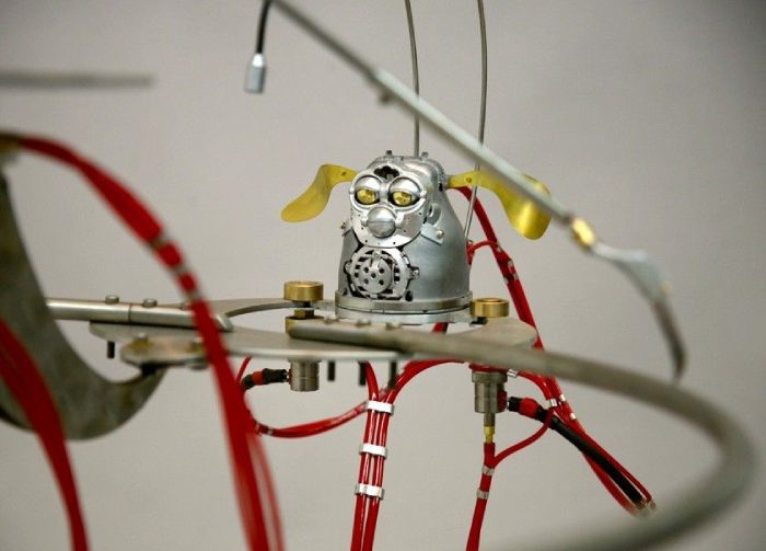 A robot with a metal head and wires.