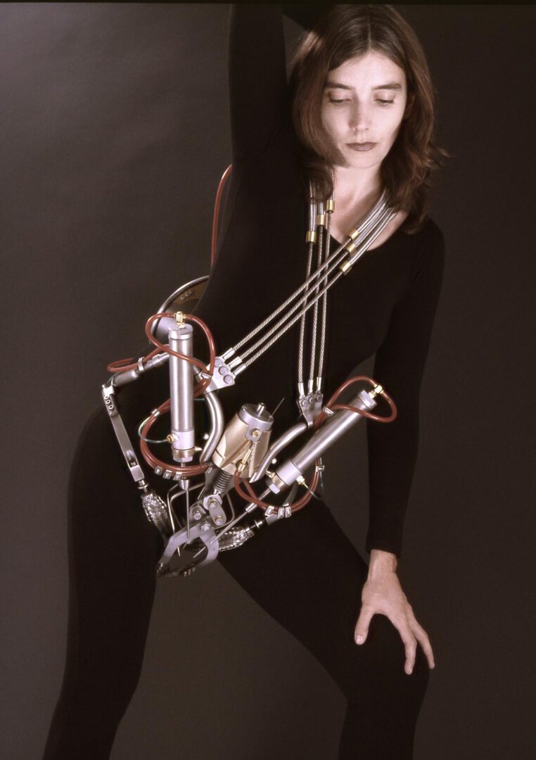 A woman poses with an interactive sculpture on her body.