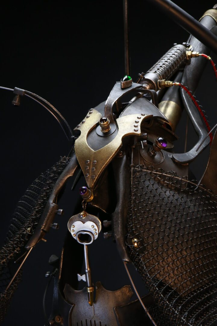 A close up of an interactive steampunk bike sculpture.