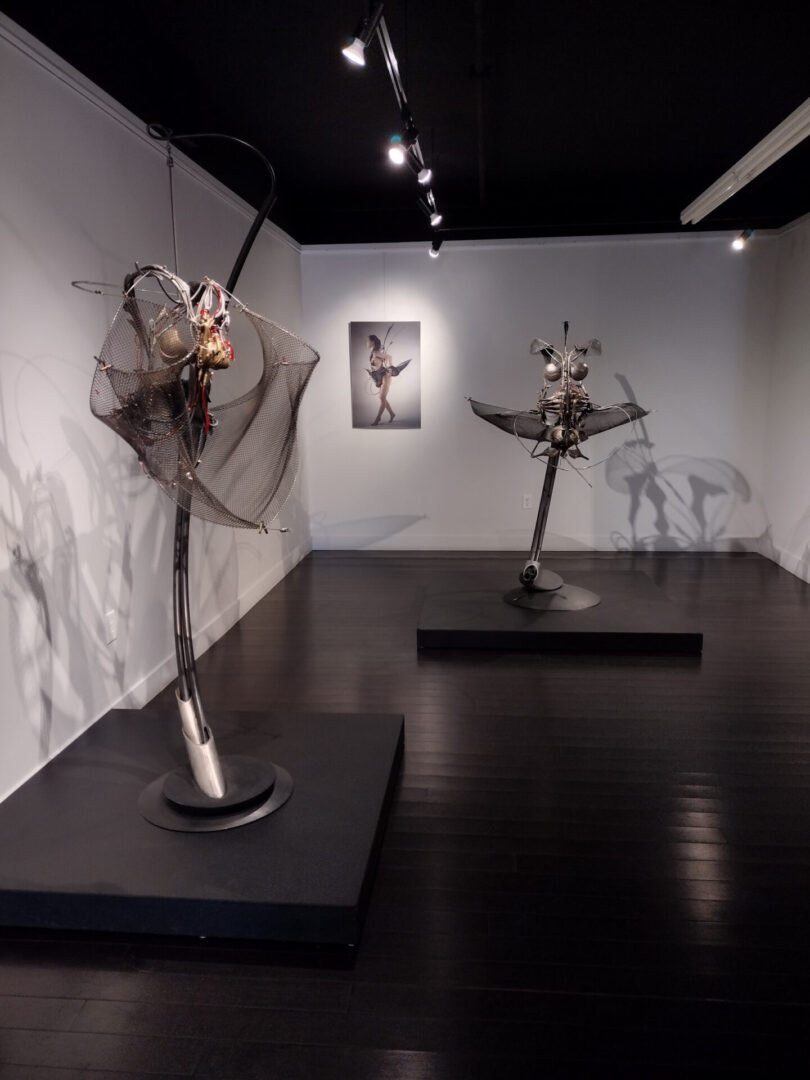 Three interactive sculptures are showcased in an art gallery.