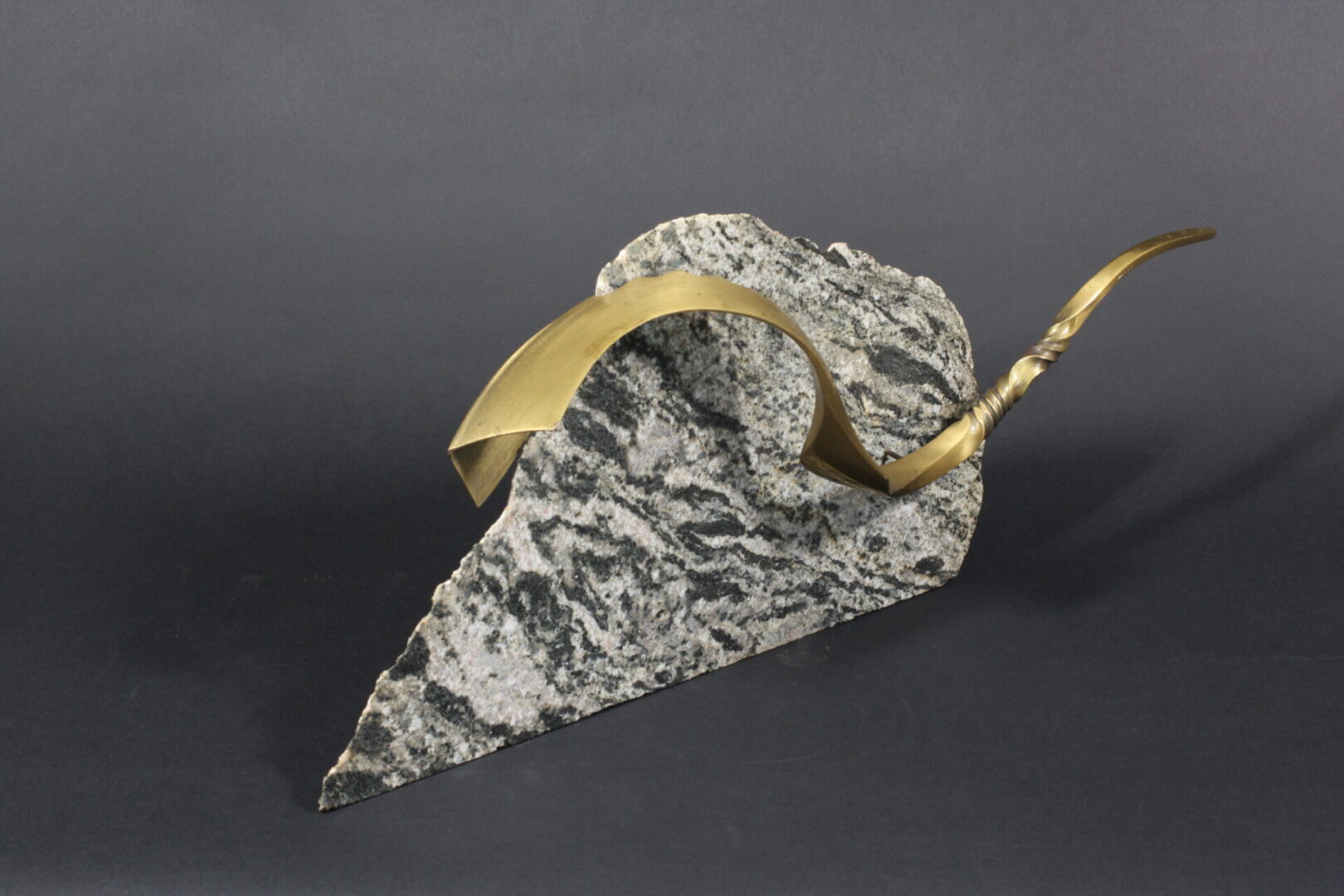 A marble sculpture adorned with gold leaf, inspired by Ira Sherman Jewelry.