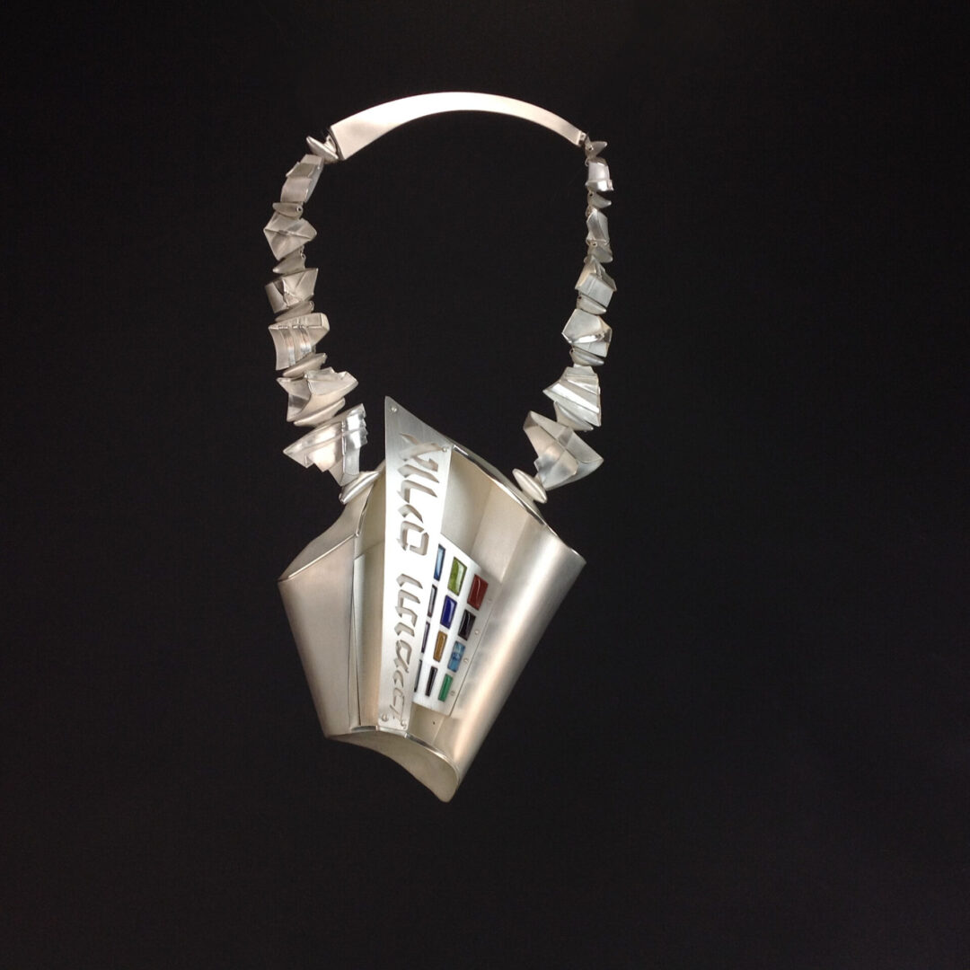 A silver necklace with a colorful design from Ira Sherman Jewelry.
