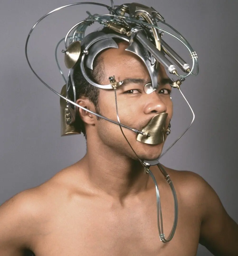 A man with a metal head covered in wires.