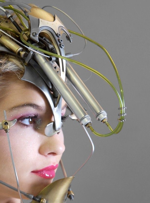 A woman's head covered in metal and wires.