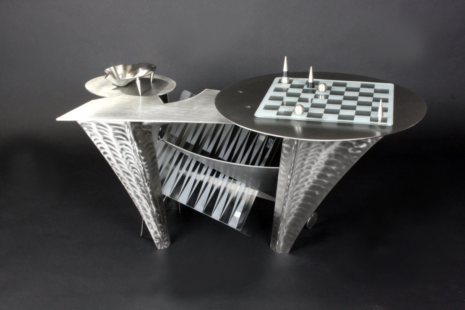 A table with Ira Sherman Jewelry chess set on it.