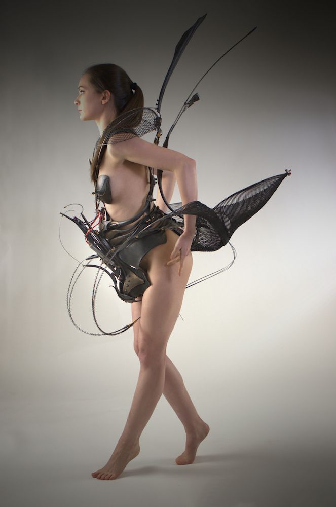 A woman wearing a dress made of wires.