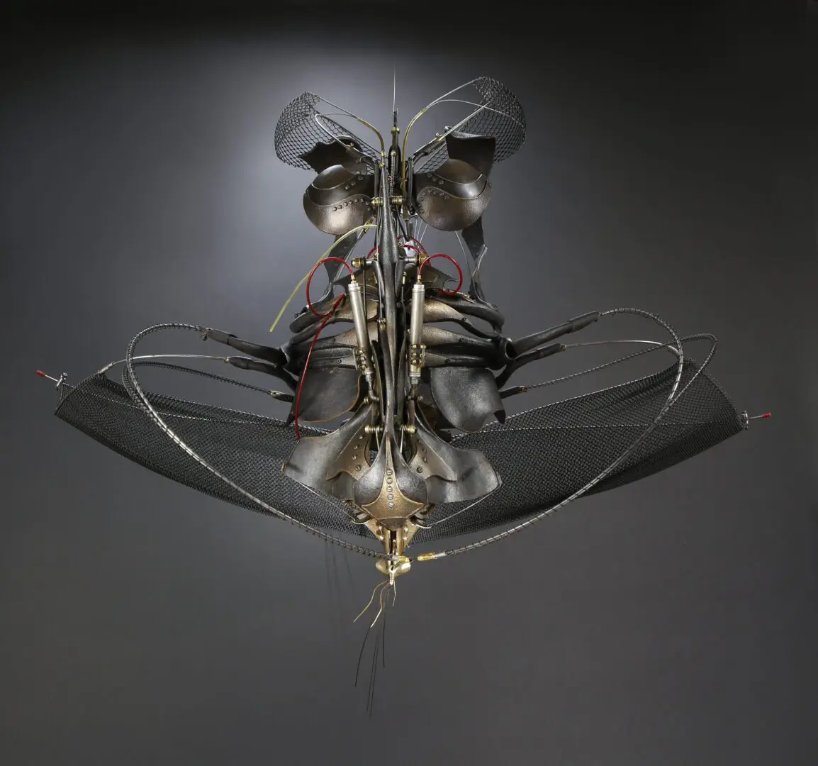 A mechanized sculpture made of metal and wires by Ira Sherman.