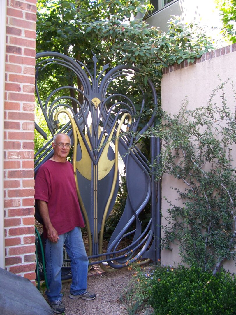 A man standing in front of a gate.