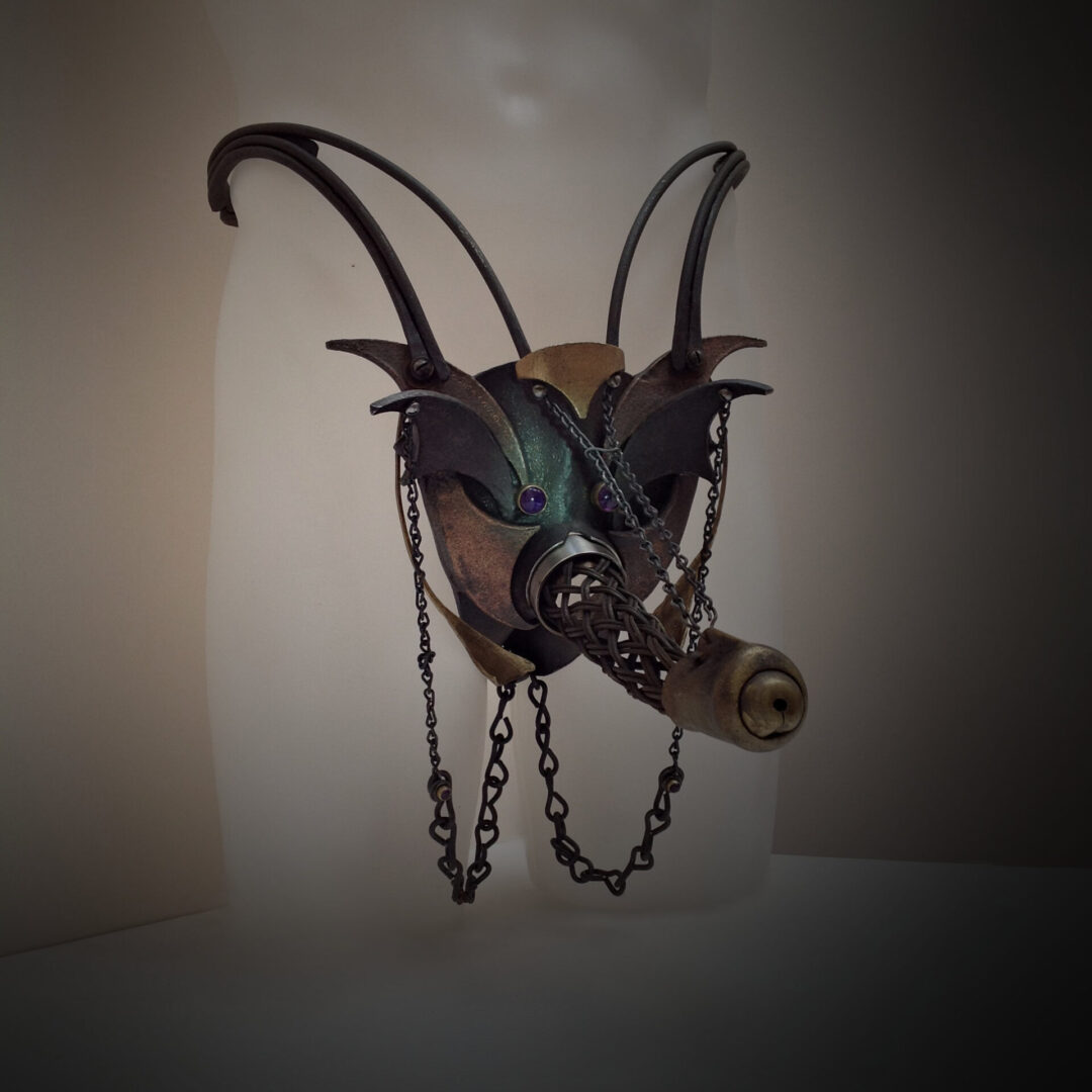 A steampunk mask with a chain attached to it.