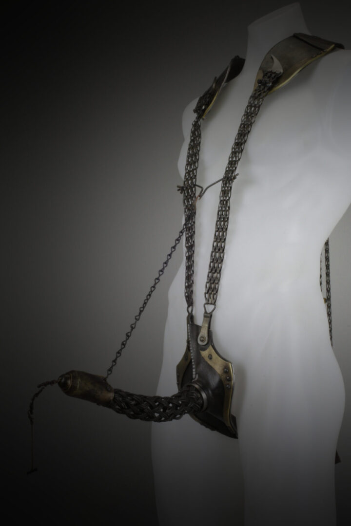 A mannequin with a chain attached to it.